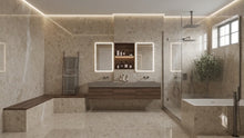 Load image into Gallery viewer, A modern luxury bathroom featuring beige marble-look , a double-sink vanity with illuminated mirrors, a glass shower enclosure, and a freestanding bathtub.