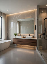 Load image into Gallery viewer, Modern bathroom interior with a double-sink vanity, large mirror, freestanding bathtub, and glass shower enclosure. The space features warm neutral stone walls and floor with recessed lighting and under-cabinet lighting.
