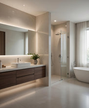 Load image into Gallery viewer, A modern bathroom interior with a floating vanity, vessel sink, large mirror, walk-in shower, and a freestanding bathtub. The space uses warm beige stone and wood tones with soft under-lighting and a small potted plant on the counter.
