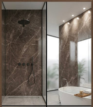 Load image into Gallery viewer, A modern bathroom interior with a walk-in shower featuring dark brown marble-look wall tiles and a black shower head and controls, alongside a freestanding white bathtub and mirrored wall.
