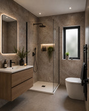 Load image into Gallery viewer, Modern bathroom interior with a floating wood vanity, white sink, illuminated mirror, walk-in shower with glass enclosure, toilet, and a window with frosted glass.
